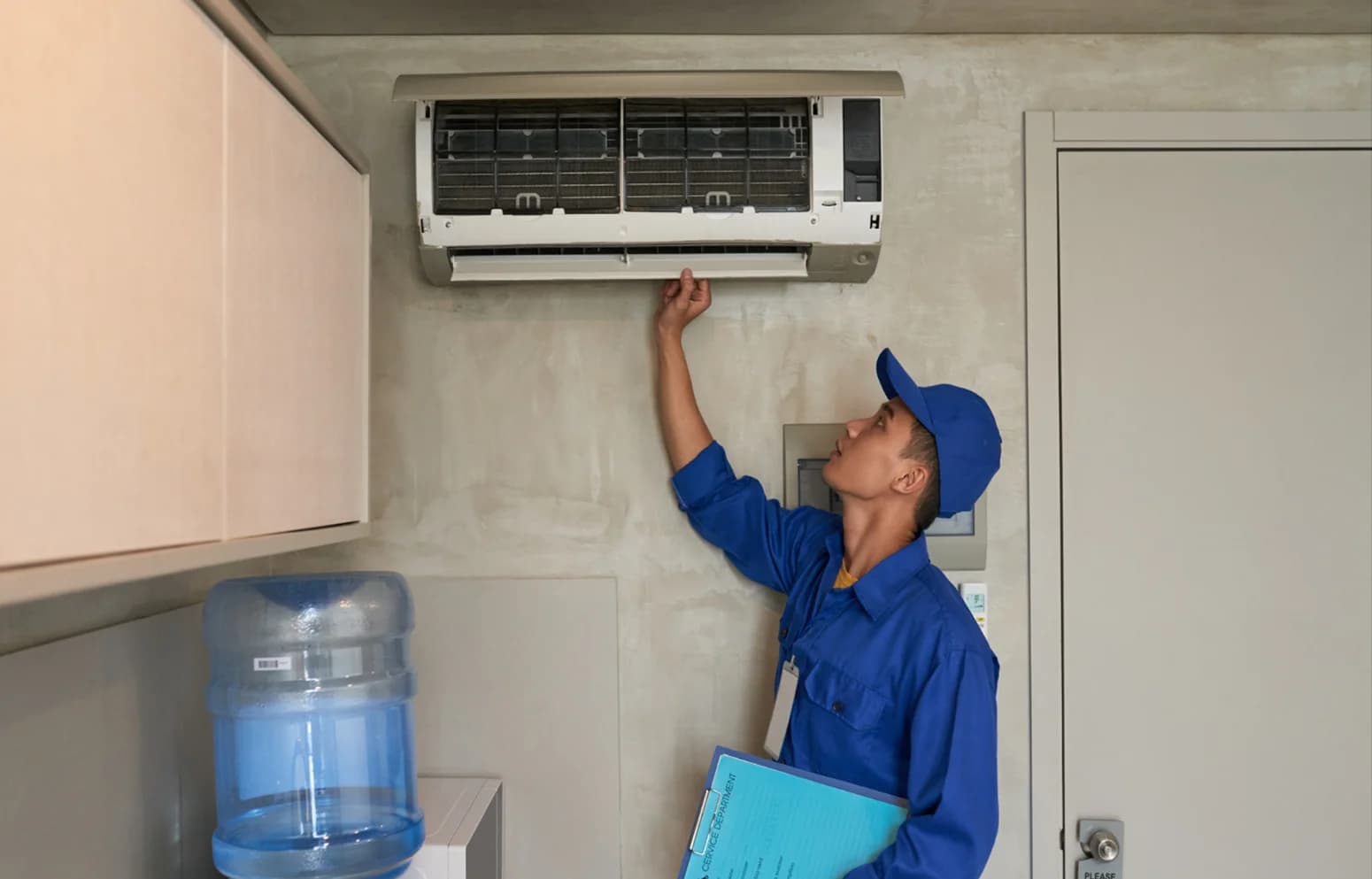 Technician servicing an air conditioning unit
