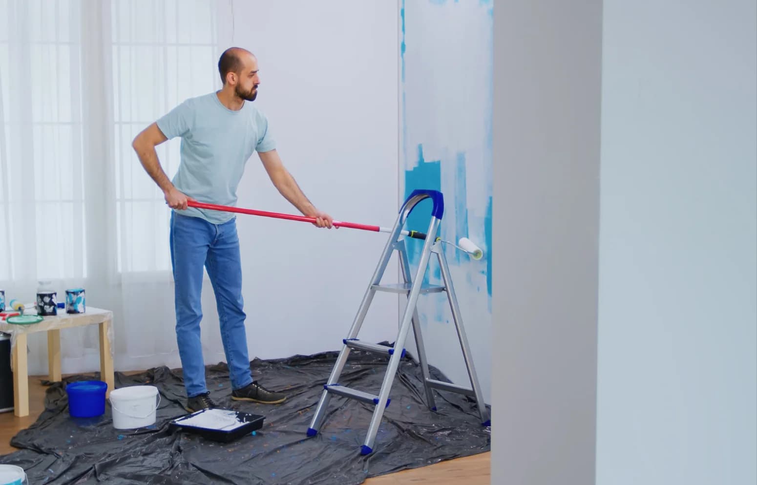 Painter refreshing an interior wall